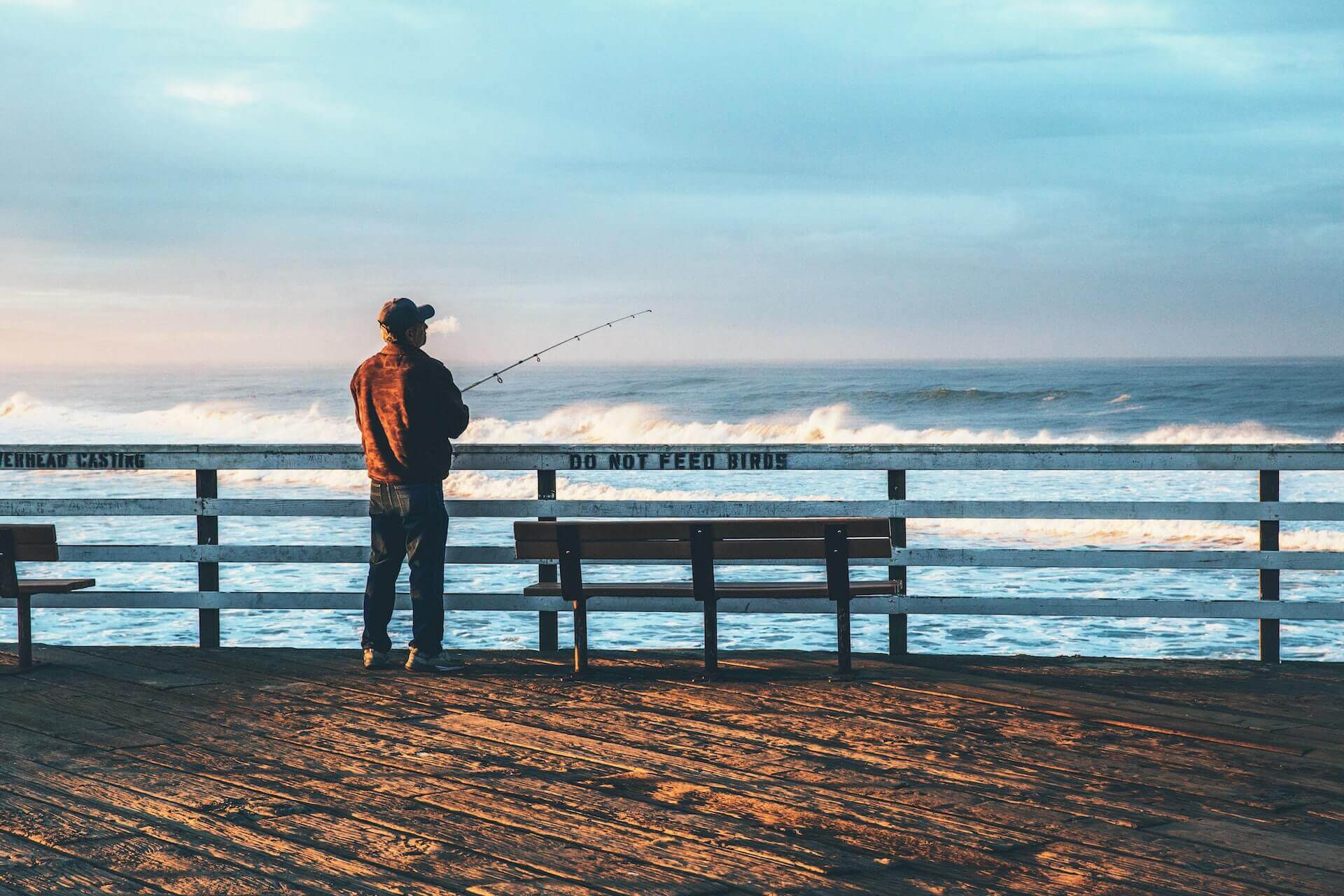 Man at a pier fishing