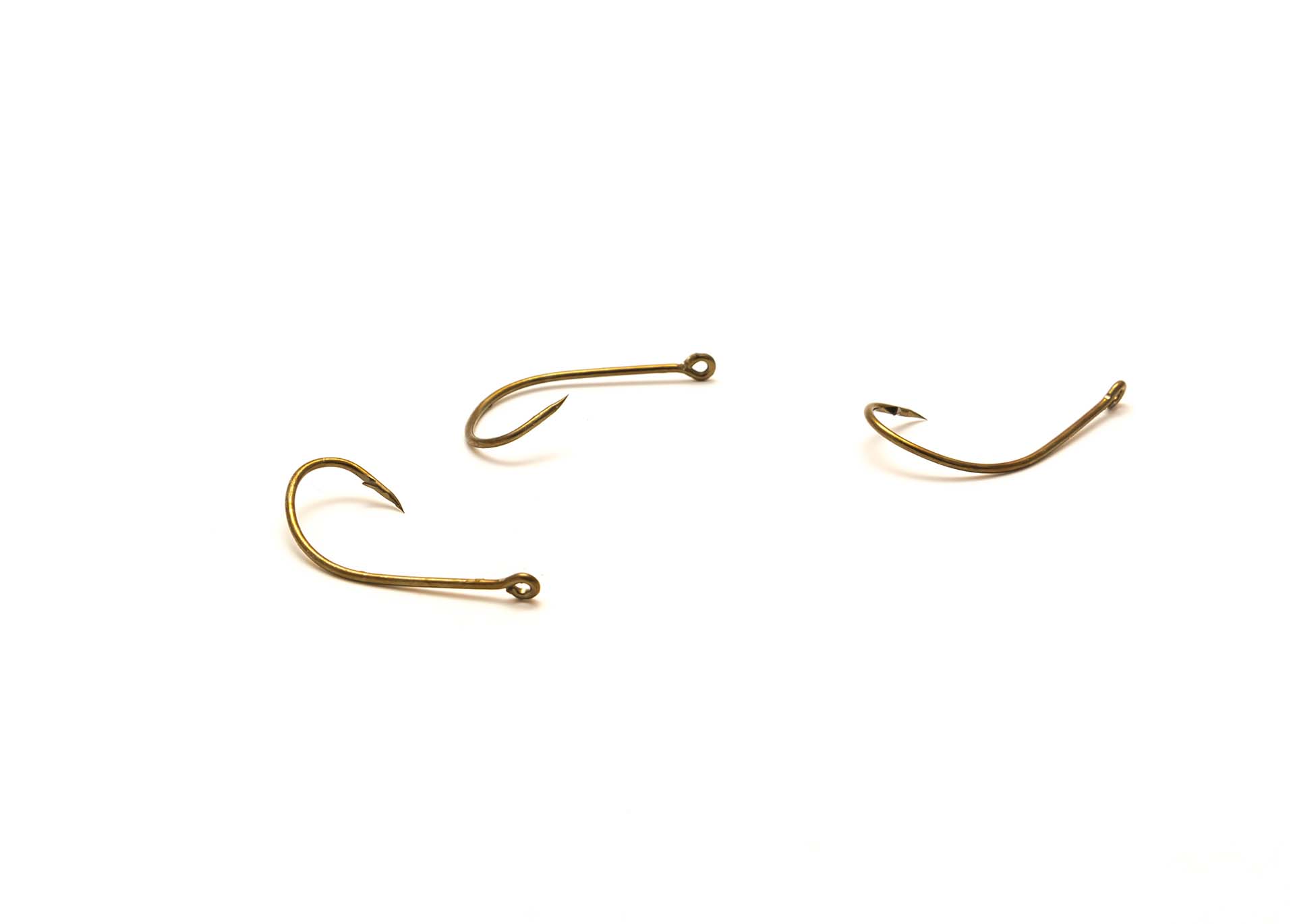 Mix of classic fishing j hooks with offset for catfishing catch isolated on white background. Fishing gear tackle accessory with clipping path and copy space.