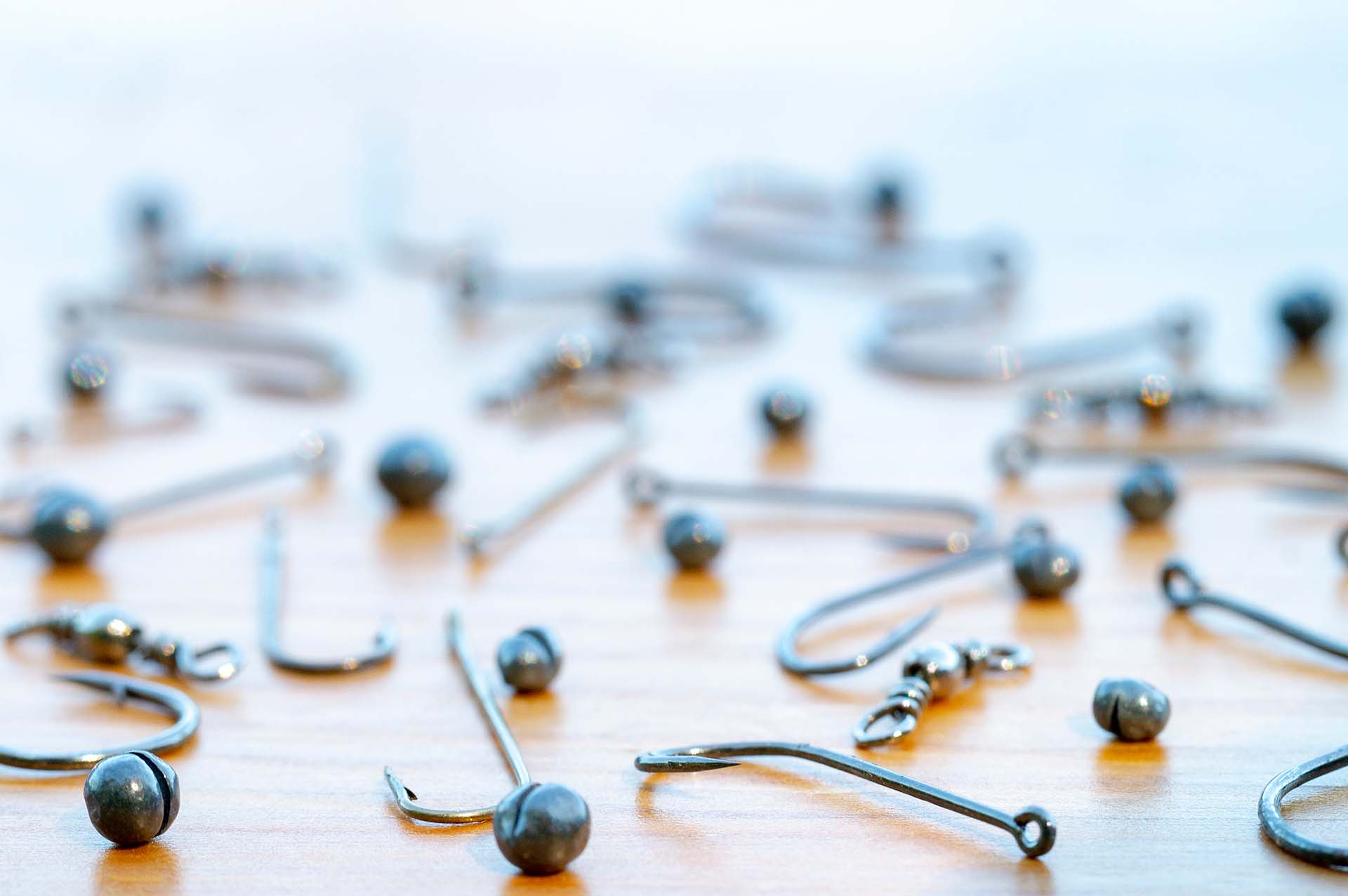 Various fishing hooks and sinkers on a table