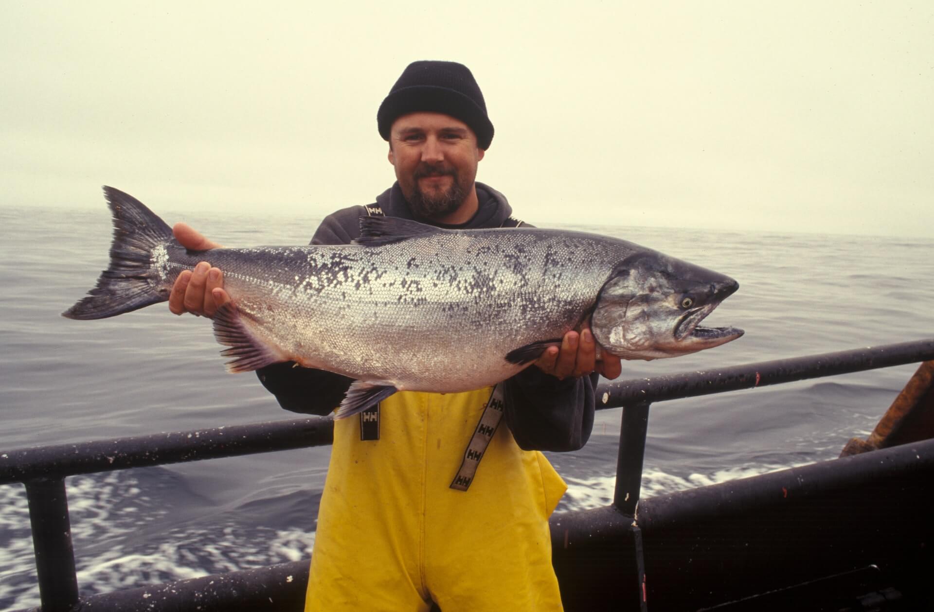 A man holding a large salmon