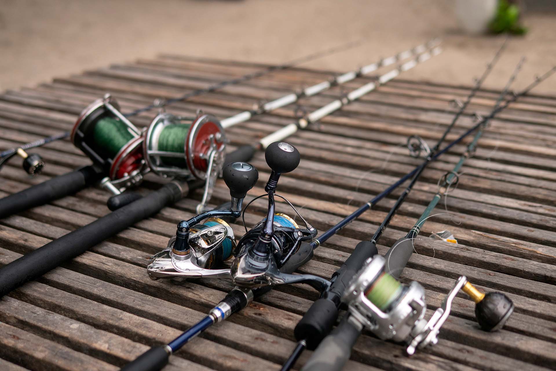 Fishing rods, reels, and lines on a wooden background
