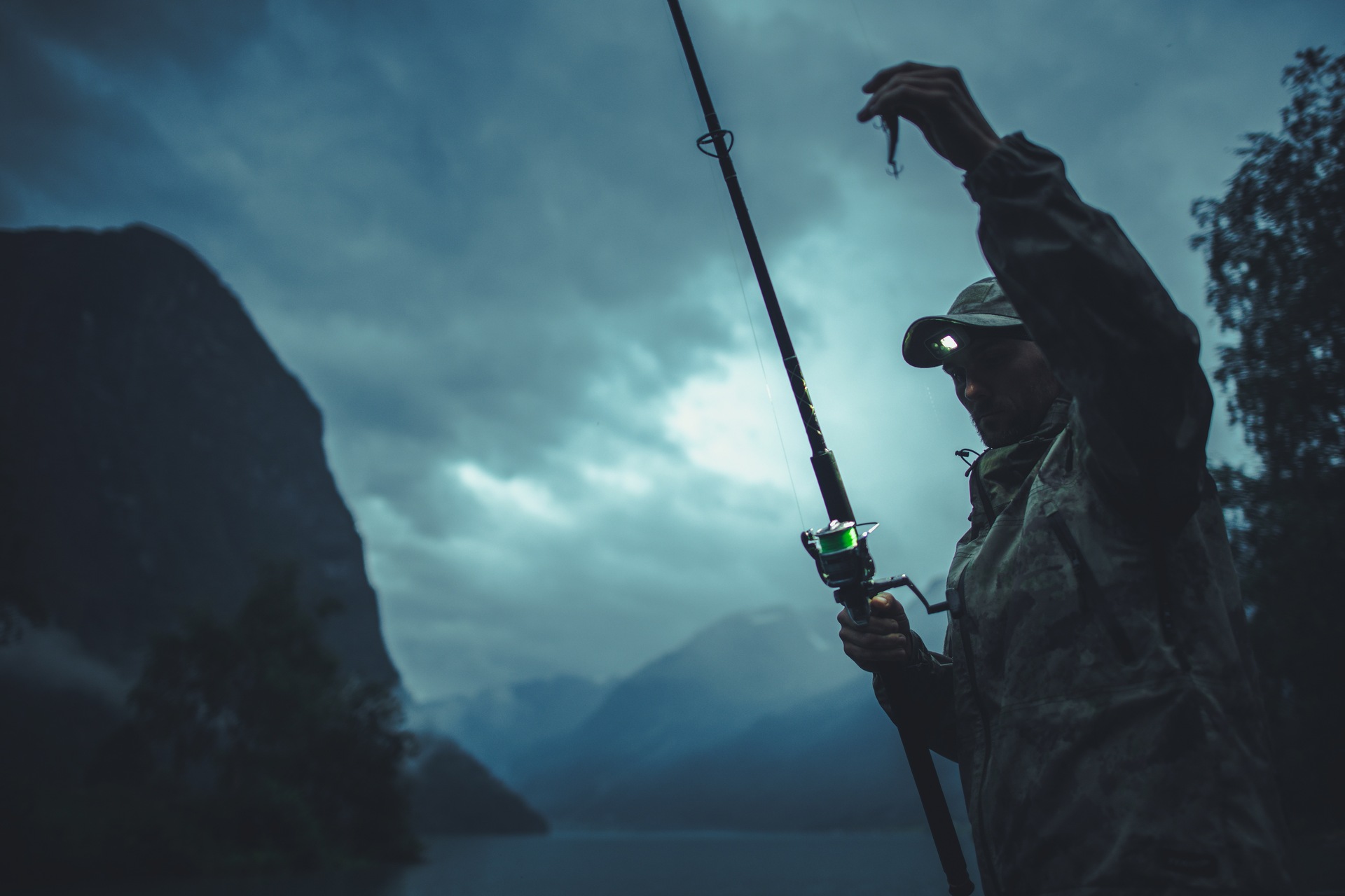 An angler holding a rod and lure