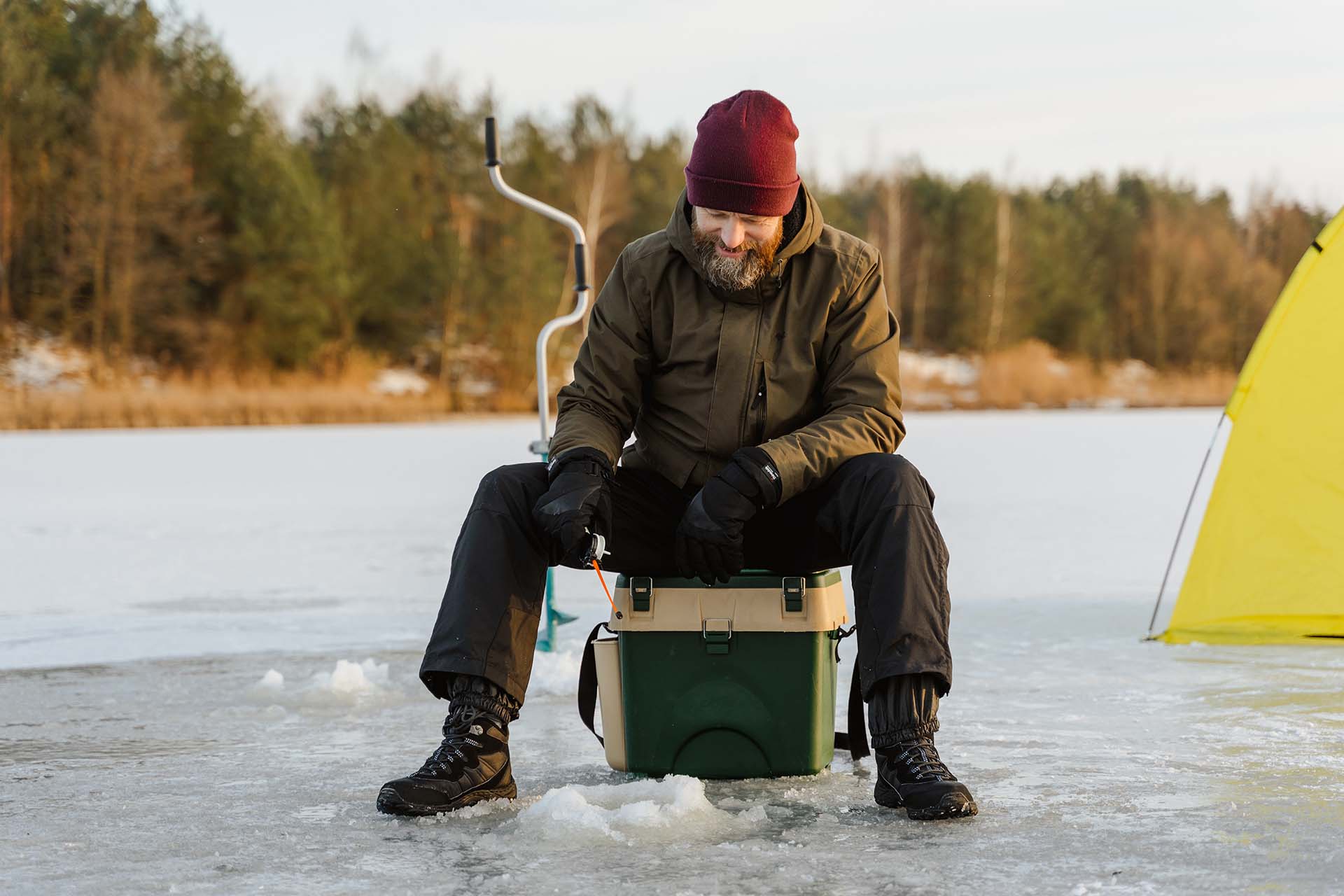 A man fishing on a frozen lake