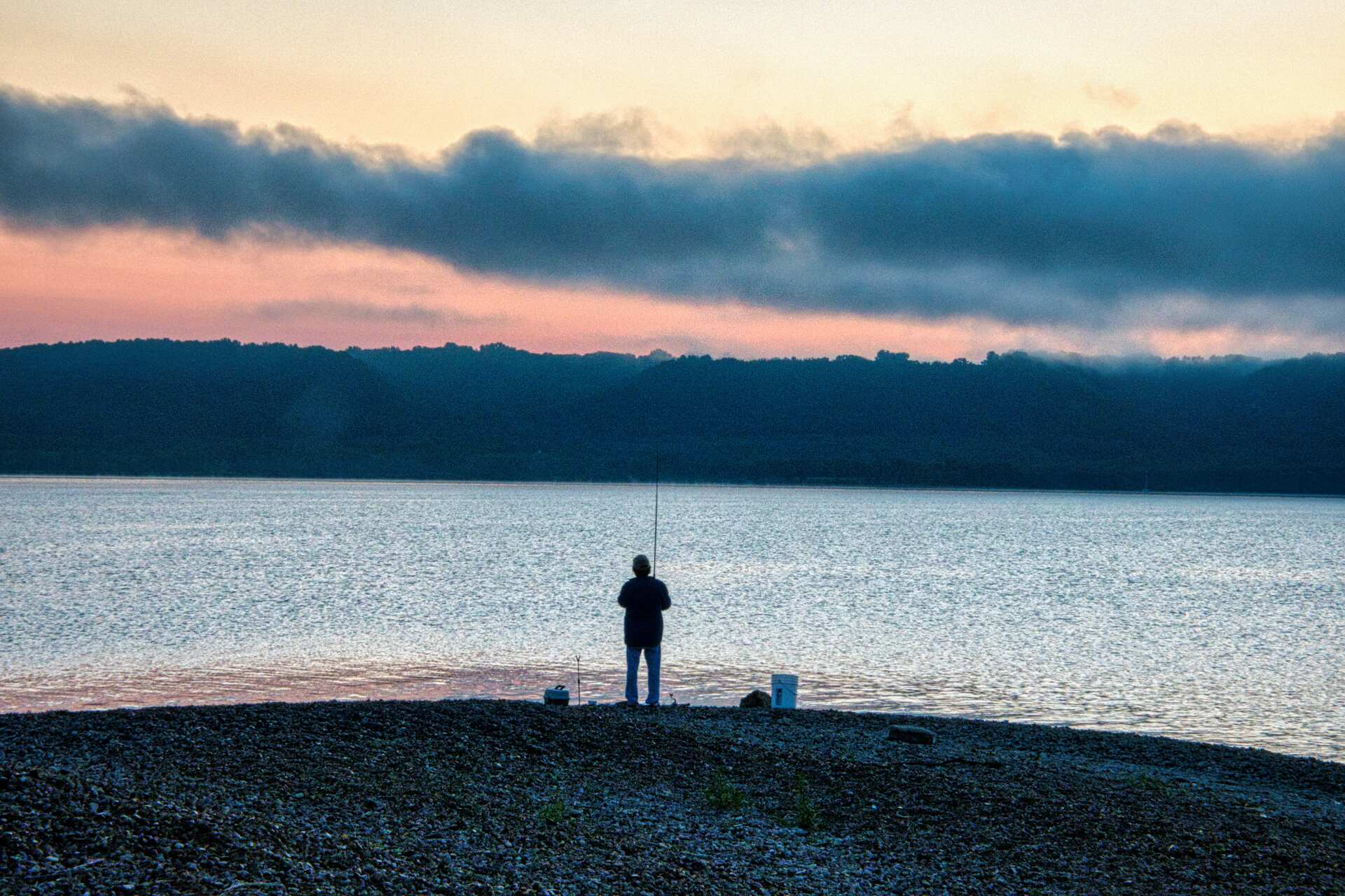 A man fishing on a shoreline
