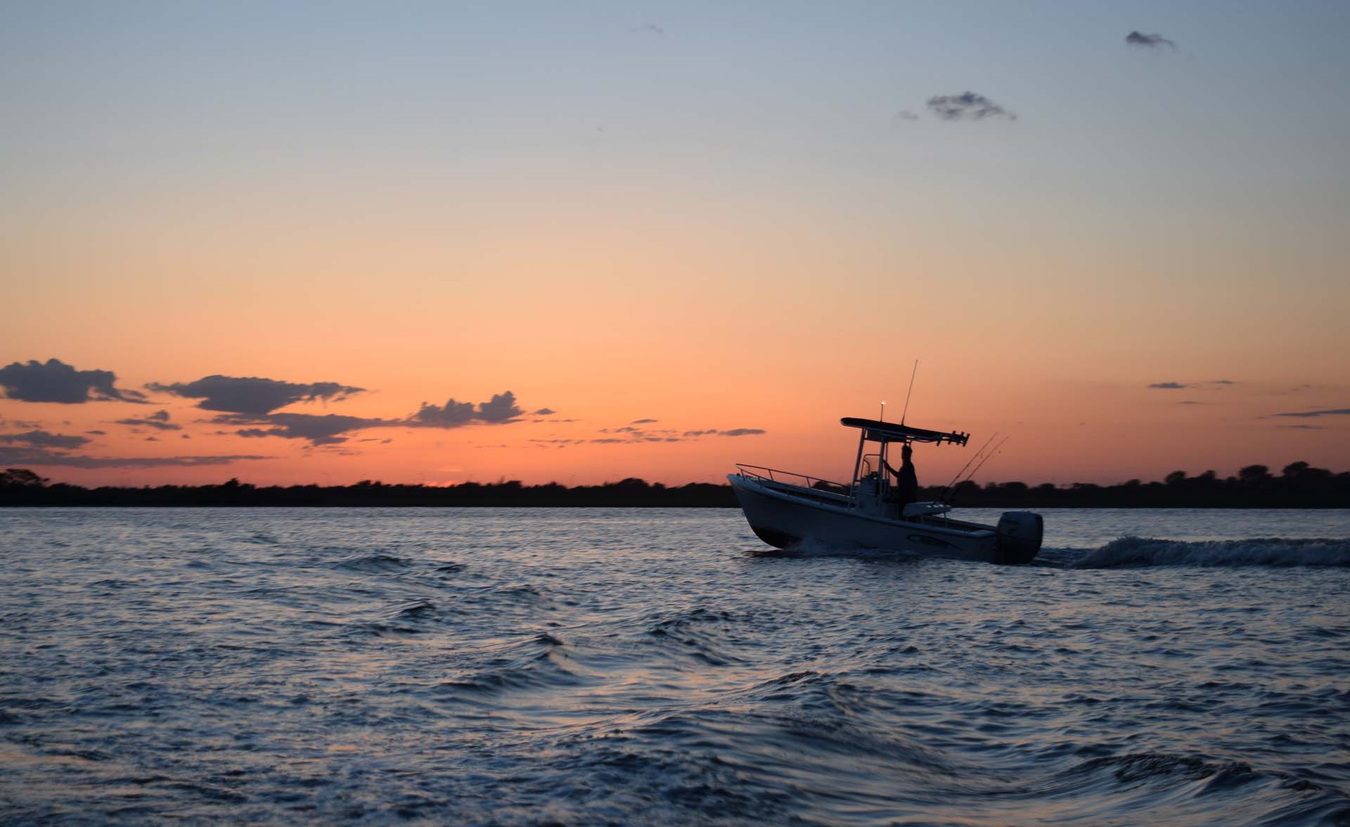 A center console boat at sunset