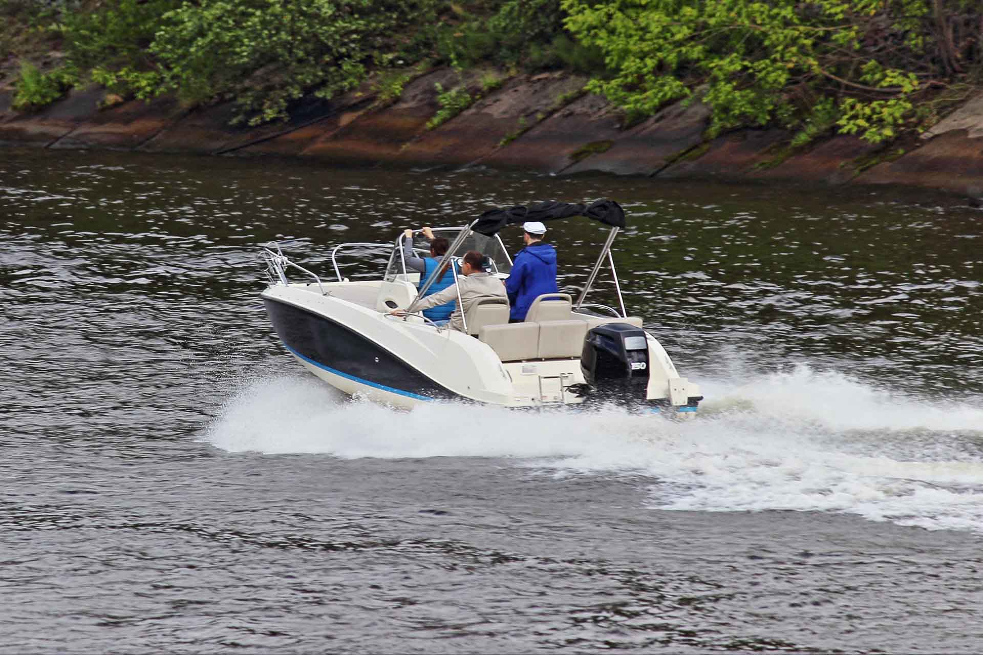 Modern open bowrider motor boat with 150 hp powerful outboard motorboat