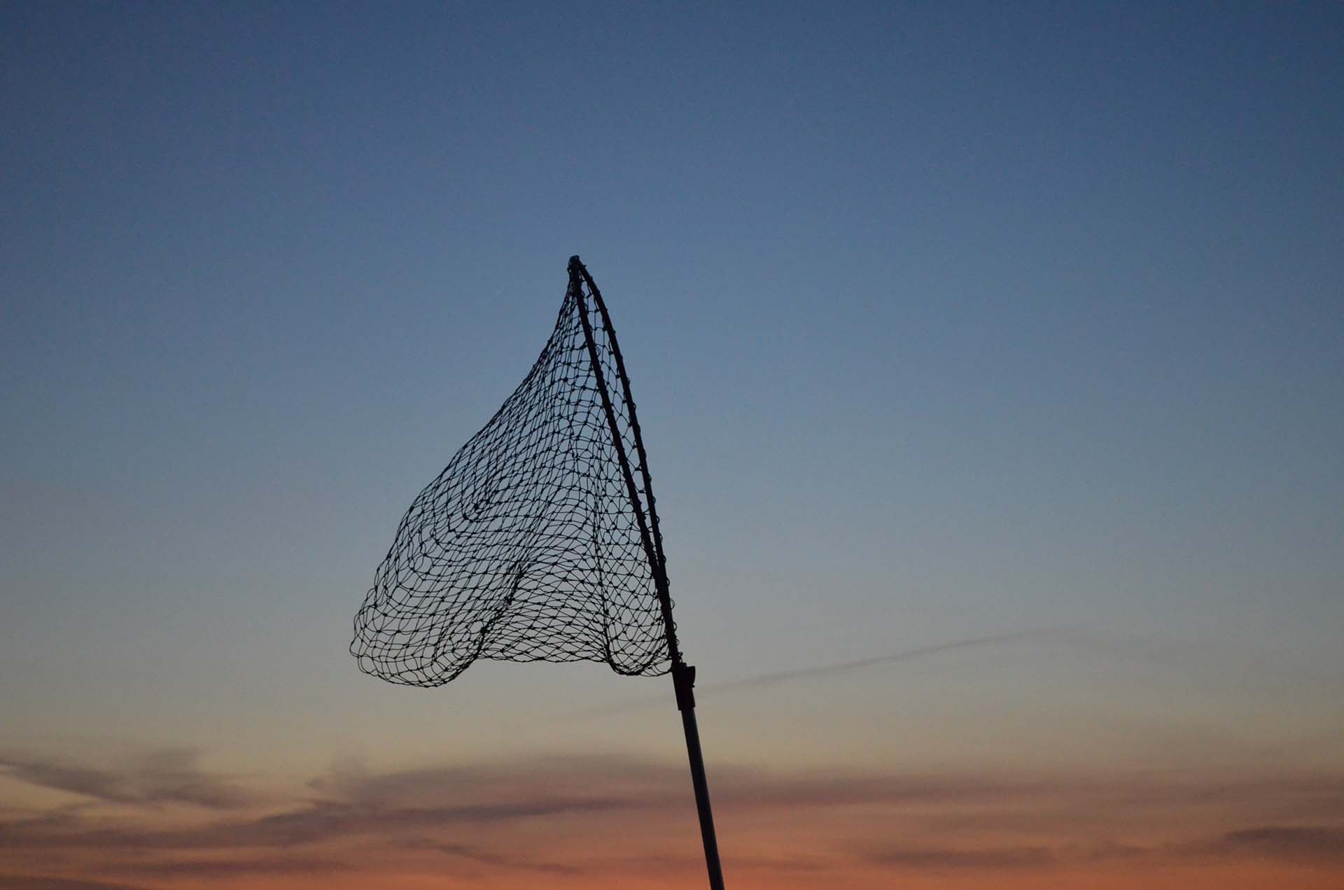 A fishing net against the sky