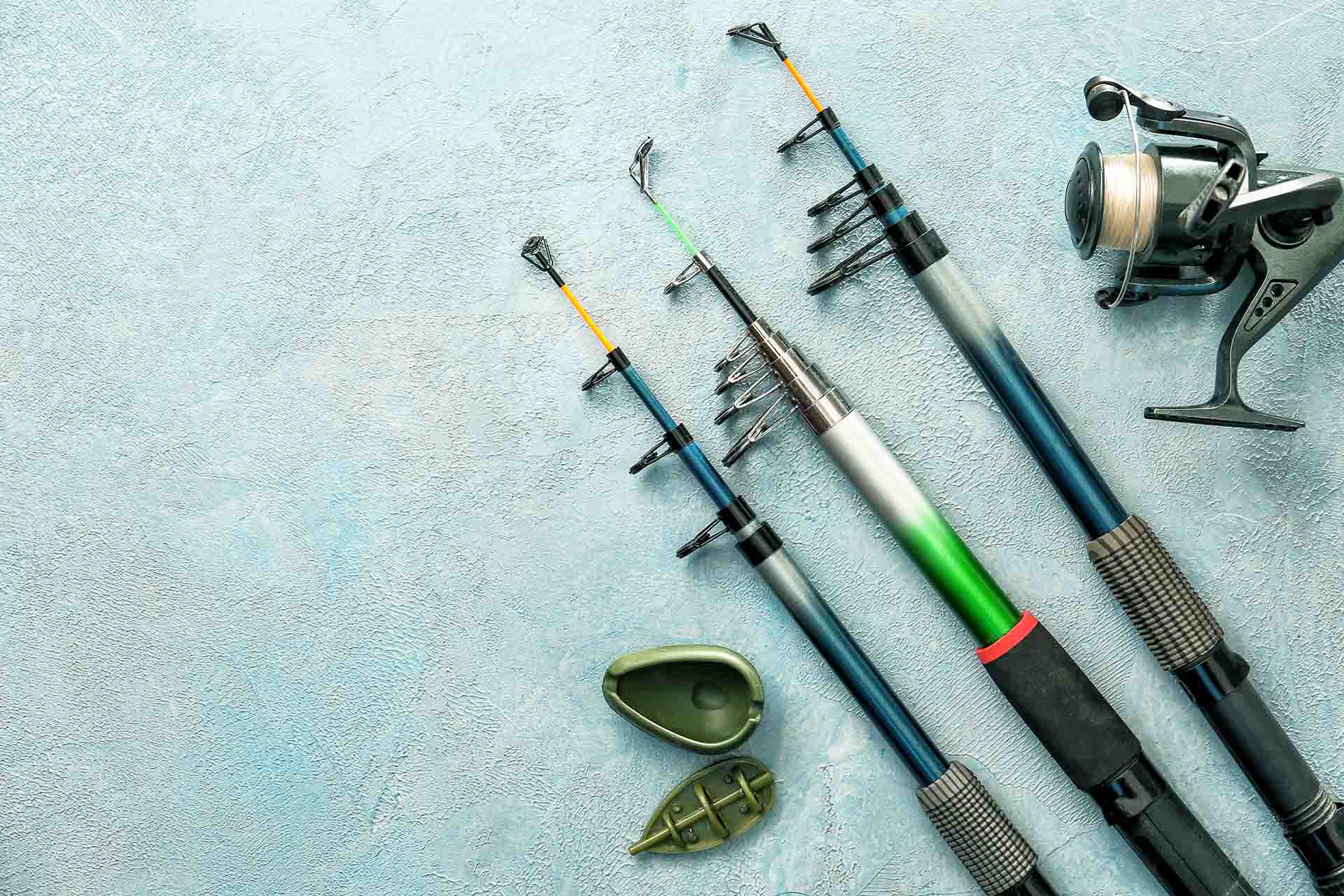 Different fishing equipment on color background