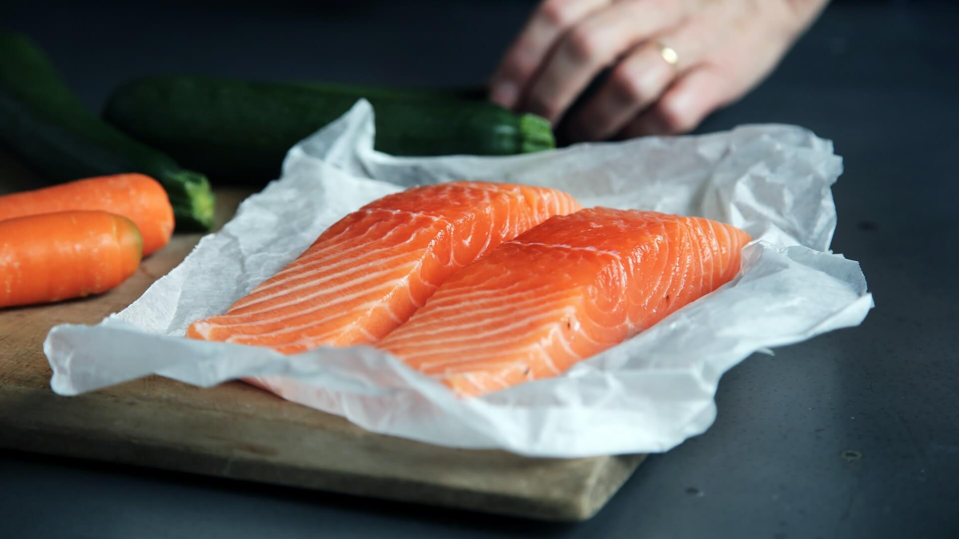 Raw salmon meat on a chopping board