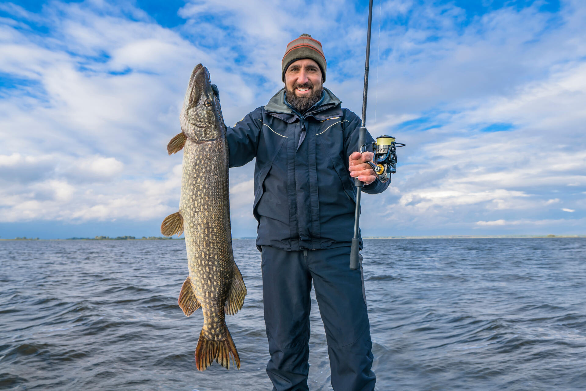 Fisherman holding a huge muskie fish