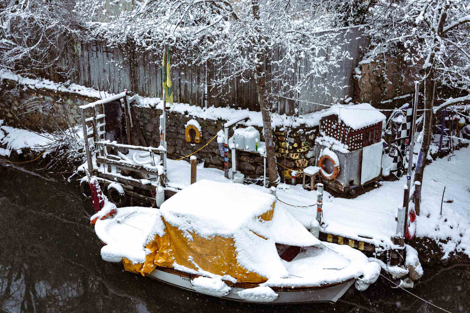 Docked boat covered in snow 
