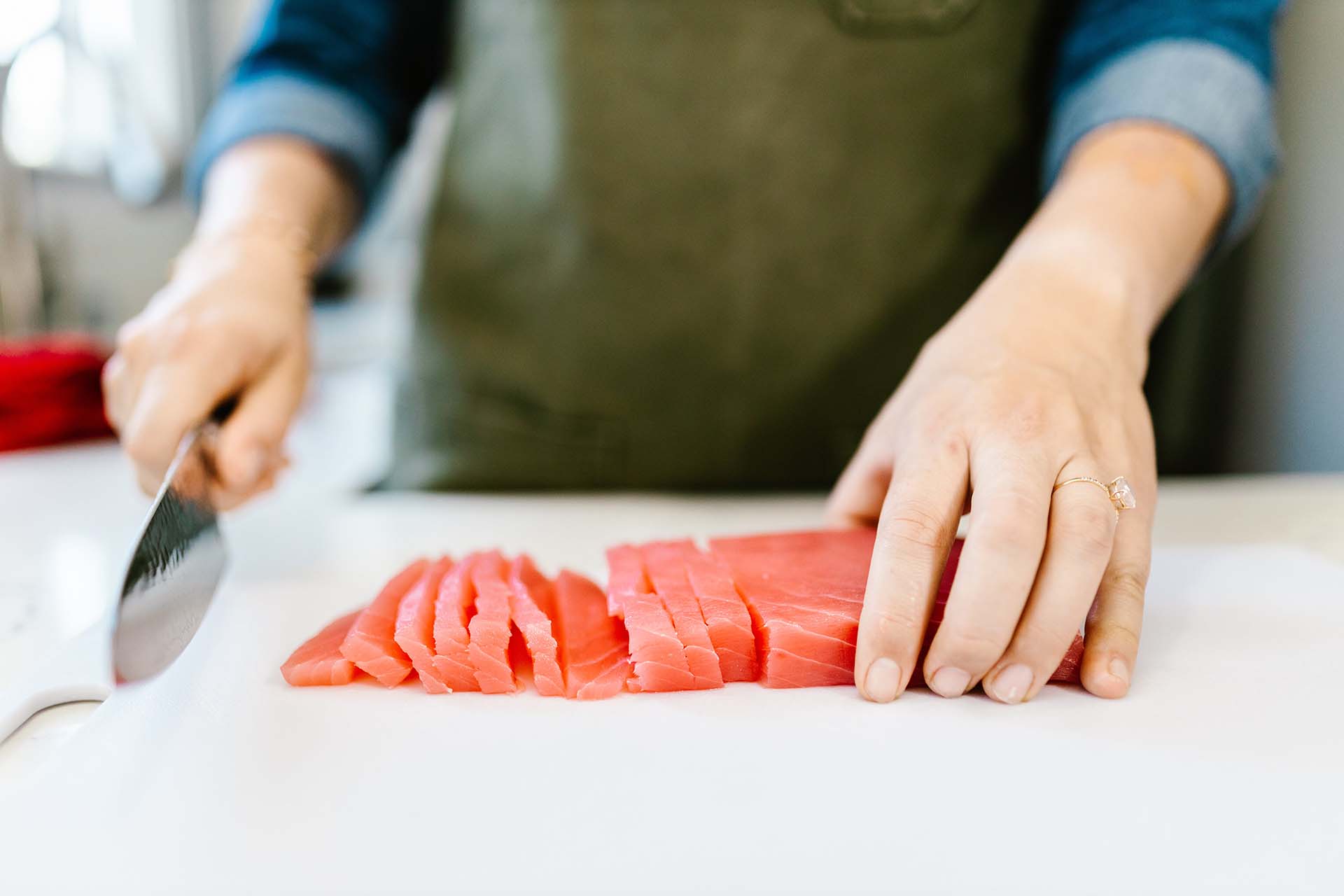 A person cutting the fish 
