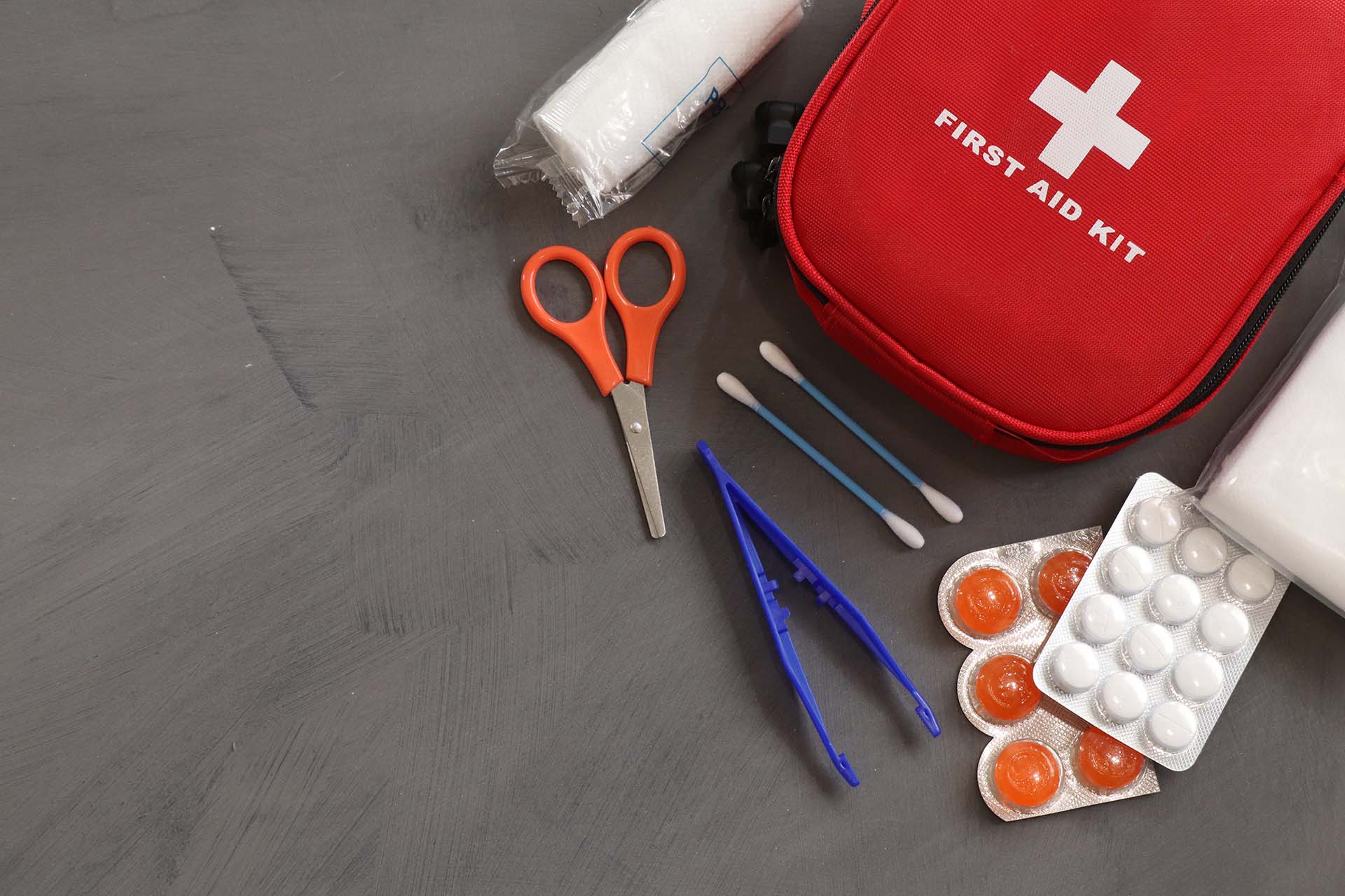 First aid kit on a gray surface  