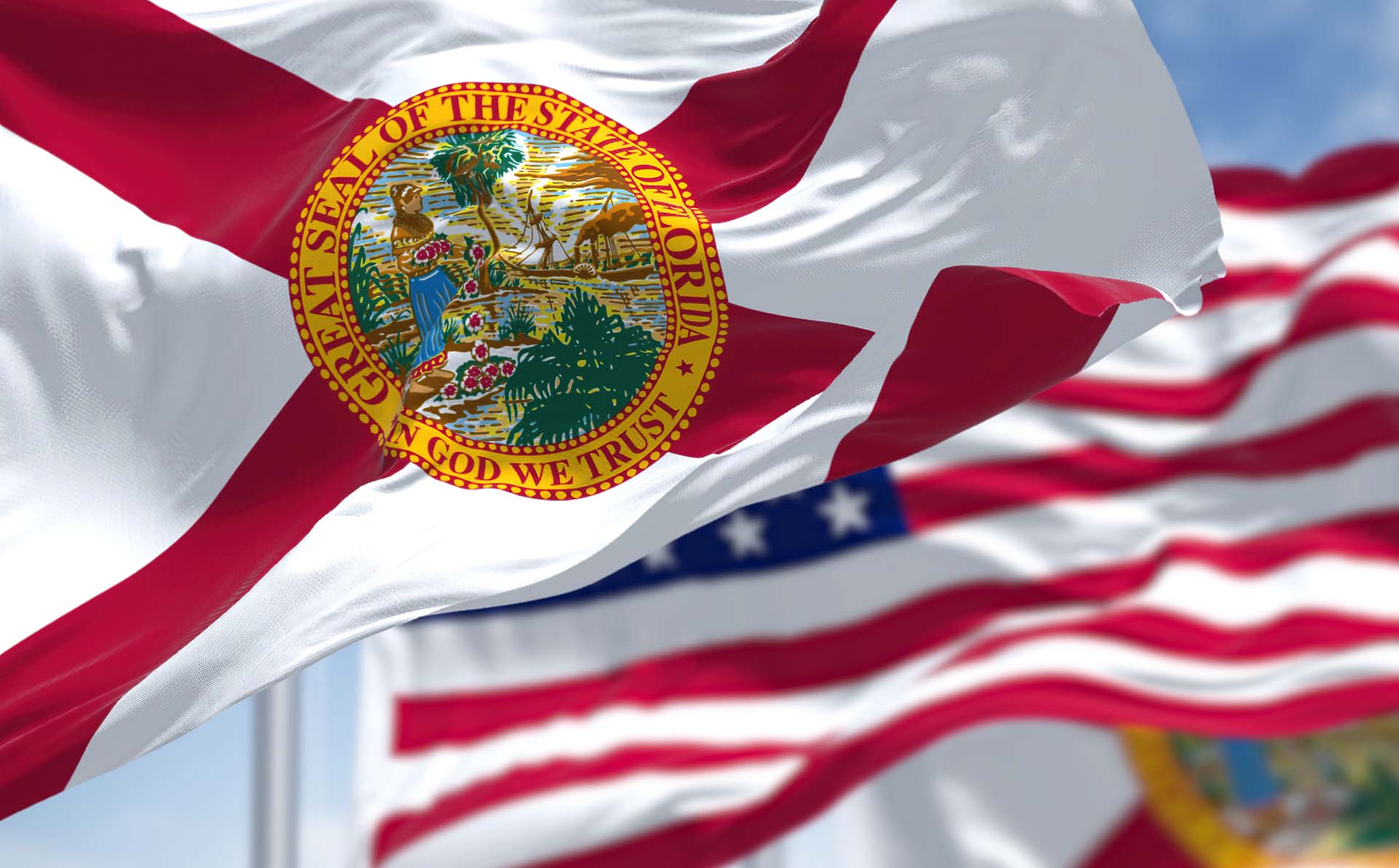 Flag of Florida state with the US flag behind it