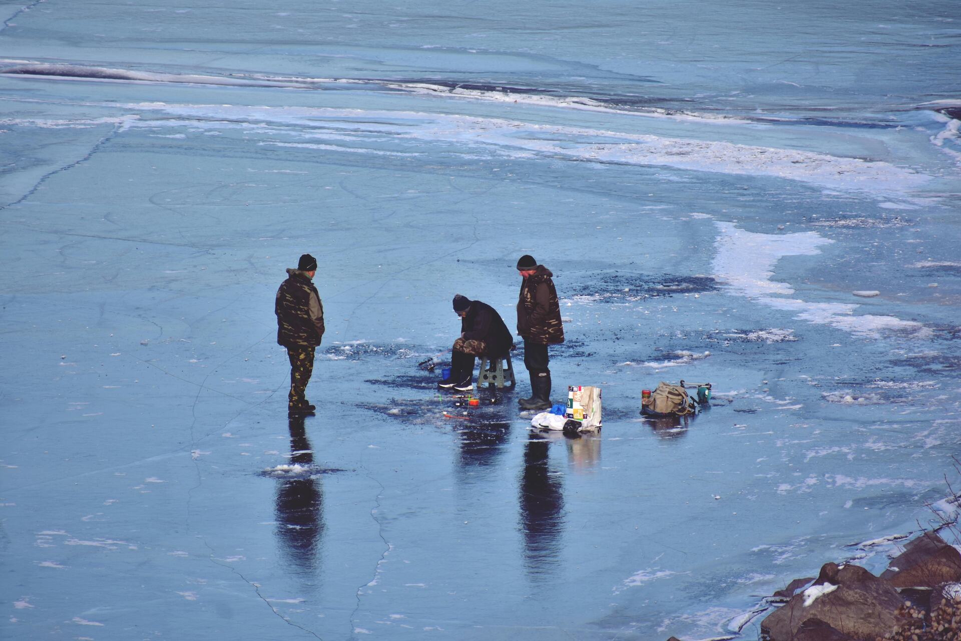 People standing on a frozen body of water