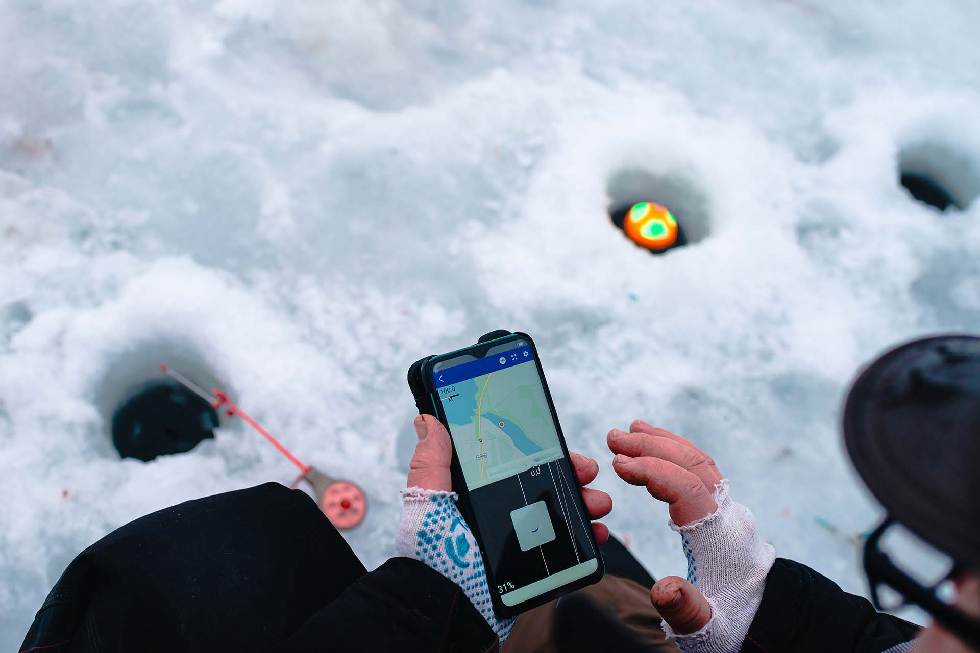 Person using an ice fishing sonar