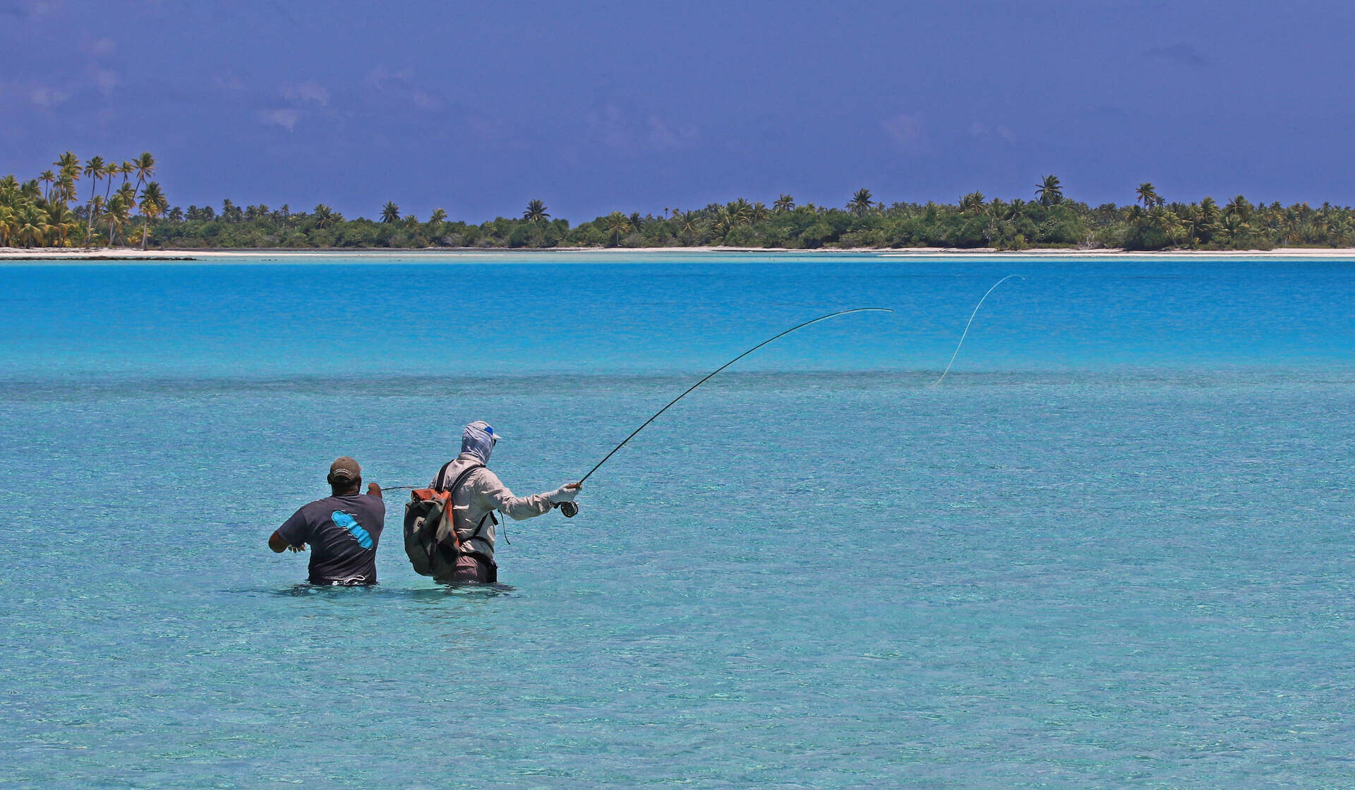 Men fishing in shallow water