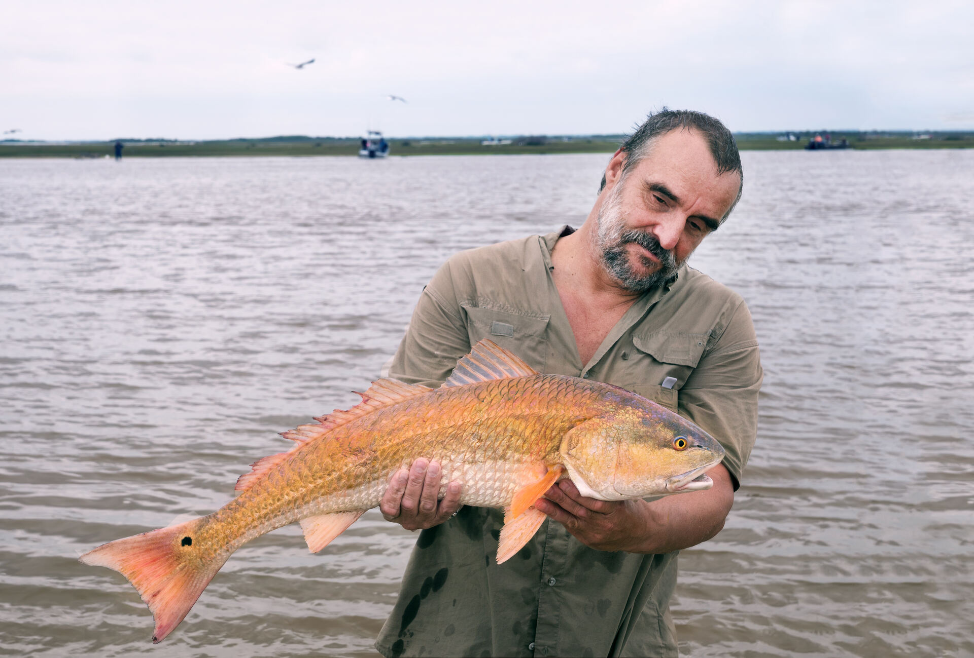 Fisherman with a big red drum