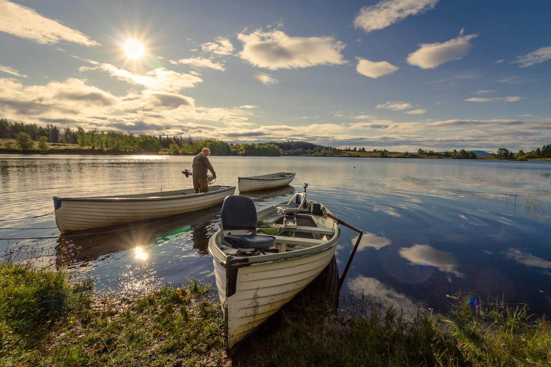 Fisherman on a white wooden boat